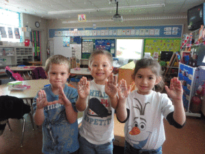To illustrate how easily germs spread, glitter represents germs on the hands of Brayson Thumann, Nicholas Ragusin & Kyndra Carriles. POC School