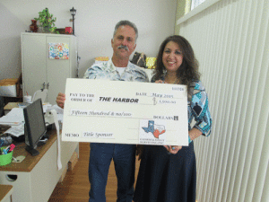 George Ganen of Ganen and Kelly Surveying is pictured above presenting a check in the amount of $1,500. Ganem & Kelly is a Title Sponsor of the 25th annual Pescado Grande.
