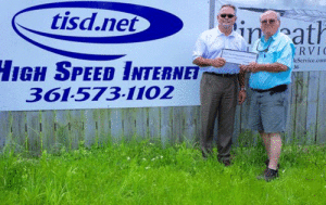 Ron Sitka (left) co-owner of TISD.net presents Bill Tigrett of POC Chamber of Commerce with a $1.000.00 “Roman Candle” Sponsorship for the 4th of July Fireworks Show. TISD (TRUE Internet Services) will soon open a Computer Store at 510 N. Virginia in Port Lavaca. 