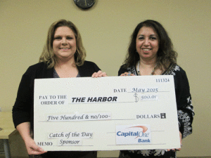 Kedra Wright, Capitol One Bank Branch Manager, presents a check in the amount of $500.