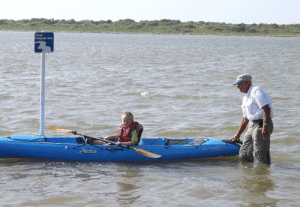 Allan Berer gives Raedyn Gee kyak lessons near the entry to the new paddling trails in Port O’Connor.