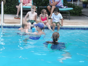 Kids learning swimming safety and techniques