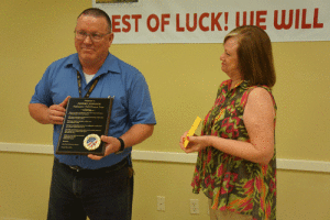 Photo above: At his August 25th Retirement Party, Postmaster Johnny Johnson is presented a plaque of appreciation by Judge Nancy Pomykal. 
