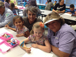 Sage Carter and Ava Salazar enjoying drawing with their grandparents at Seadrift School.