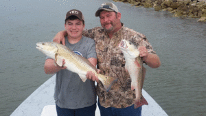 Father & Son Team Trey & Cordy with 2 slot reds. - Capt. Jeff Larson