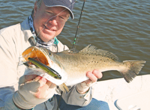 Phil Brannan used a slow sinking mullet imitation plug to catch this big trout while fishing with Capt. Robert Sloan. Some of the best winter trout fishing in Port O’Connor can be had while wade or drift fishing on clear water flats over sand and grass. Capt. Robert Sloan photo.