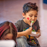 Second grader Alex Lopez enjoys the tasty green eggs and ham cooked by Speedy Stop volunteers.