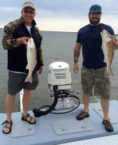 Chris and Casey from Bentonville, Arkansas with a pair of April Fool’s Day redfish that they caught while fishing with Captain RJ Shelly.