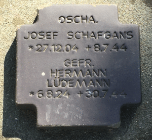 German Tombstone at La Cambe German Cemetery, the soldiers are buried two to a grave. Josef Schafgans was a Waffen-SS cameraman killed in Normandy.
