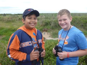 POC 4th and 5th grade students enjoyed a trip to Formosa Wetlands. Sergio Sanchez and Gage Spencer study the wildlife. (Notice the alligator in the background.)