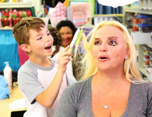 Kindergarten student Corbin Washburn gives his mom, Sarah, a “makeover” to celebrate Mother’s Day at Port O’Connor School.
