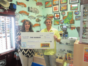 The Harbor’s Maria T. Walton thanks Donnie Klesel of POC Rod & Gun for his generous donation to the annual Pescado Grande Fishing Tournament to be held in POC June 25th.