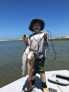 The big boats may be offshore catching the really big ones during Poco Bueno, but Weston Kane, age 9, did pretty good closer in. He caught his first keeper redfish, 23 and 25 inches, while fishing with grandfather, Joe Wiatt.