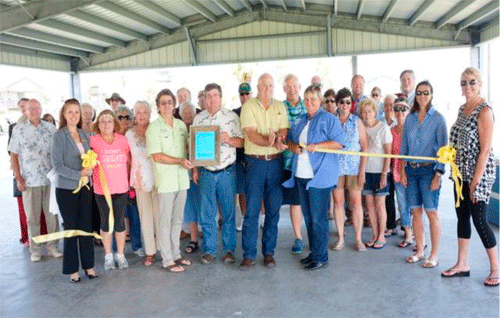 Pavilion Dedication, in center of photo are Commissioners Vern Lyssy (holding plaque) and Kenneth Finster (yellow shirt).