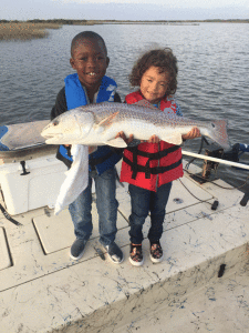 Six-year-old Lamar and four-year-old Symone, really enjoy fishing with grandpa Ranier Brigham. Lamar landed this 32 1/2” redfish all by himself.