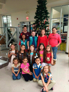  Girl Scout Troop 9510 help decorate the Calhoun County Public Library Christmas tree.