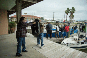 Volunteers Unload Toys from Toy Run Boats -Photo by Fred Carr