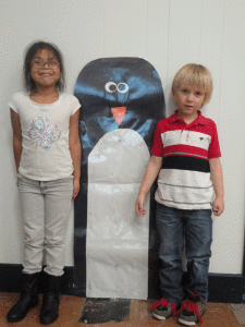 In Ms. Peters’ POC School Kindergarten class, students were studying penguins and learning about making comparisons. Students compared their height to the penguin to see if they were taller than, shorter than or the same height as the Emperor Penguin. Layla Banda and Dalton Fowler compare themselves to the Emperor Penguin 