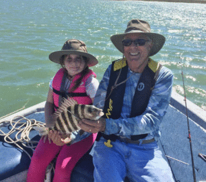 Dave Pope and his granddaughter, Ayelet Parker, who is a fanatic and, also, a fantastic fisher girl. On Thursday, February 23, she caught this nice sheepshead along with 8 or 10 more of similar size. In addition she caught 4 nice keeper trout they fried up for dinner. All were caught on live shrimp. The enthusiasm shown by kids when they enjoy fishing is highly contagious! Take one fishing and you will see!