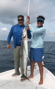 Augie Deering (17), pictured with his father Gus Deering, caught and released this beautiful kingfish.