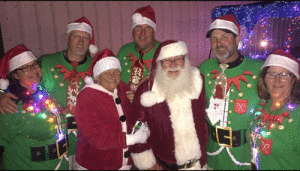 Santa & Mrs. Claus with their Lighted Boat Parade elves