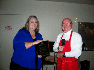 Doyle Adams presents Kelly Gee with the Citizen of the Year Award at the Sweetheart Banquet,