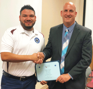 Cesar Reyna, left, of Port Lavaca was one of 11 students of Victoria College’s Emergency Medical Services Program to be honored on May 8 for graduating from VC’s Emergency Medical Technician course. Pictured with Reyna is Victoria College President Dr. David Hinds.