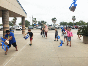 Seadrift School’s Art Class made kites out of paper bags. They enjoyed flying them in front of the school.