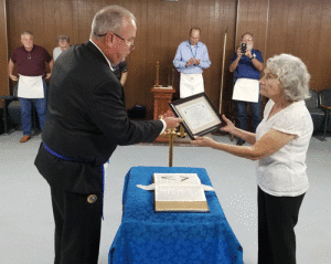 Deputy Grand Master Mike Calhoun presents award to Joyce Rhyne, Editor of Dolphin Talk