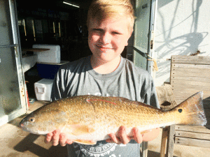 Sam Lack with his tagged Redfish Wins $25,000 Scholarship in Texas Star Tournament