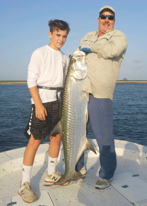 13-year-old Weston Klutts and Capt. RJ Shelly.  Weston caught this Tarpon on July 30th at the Jetties.  Weston fought the fish for 50 minutes before a quick picture was taken and the fish was released.  A large school of tarpon were feeding on the surface, this fish hit a sardine.   
