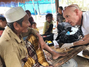 Doug Bennett tends to a wounded villager.