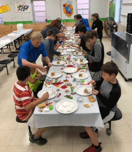 Shaney Bradford shows local POC Elementary students how to make a gingerbread house. Each child created and took a gingerbread house home thanks to the generous supply donation by Shaney. The Friends of the Library Board Directors volunteered their time to help with the gingerbread house assembly. It was a great time had by all and we heard that the houses were both beautiful and delicious! Photo by M. Marlin