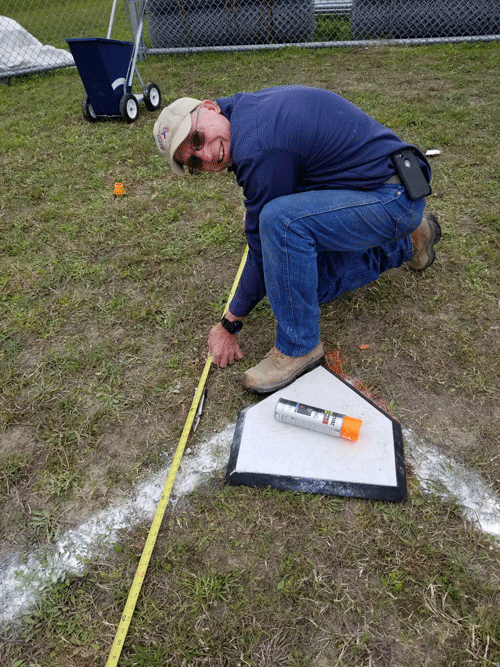 Joe Krenek marks the baseball field.