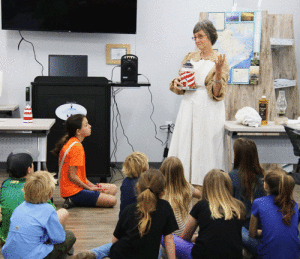 Mary Bell Meitzen, Calhoun County Historical Commission dressed in period costume and explained the history of the lighthouse and what it was like to be the lighthouse keeper out on Matagorda Island. The children made their own lighthouse drawings and enjoyed snacks and beverages. Another excellent program by our Children’s Program Committee!				-Brigid Berger 