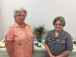 Hostesses Connie Hall & Judy Overton prepare for the Hooked on Books meeting.