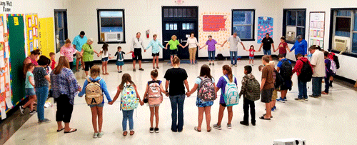 Port O’Connor School: On September 25, students, parents, and community members joined hands to pray at the annual See You At The Pole student day of prayer.  Though the mosquitoes forced them inside for the event, they still continued to praise God.-Candice Stryker