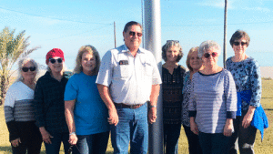 Members of the Port O’Connor Community Service Club stand with Commissioner Gary Reese at the base of the new flagpole, one of their community improvement projects for 2019. The Service Club meets the first and third Thursdays of the month at 10:00 a.m. at POC Community Center. All community-minded ladies welcomed.
