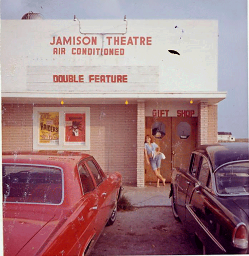 This photo was posted on the “Remember When in Port O’Connor” site. Patrick Barnes took this photo of his (future) wife, Claire, in front of the Jamison Theatre in 1965.