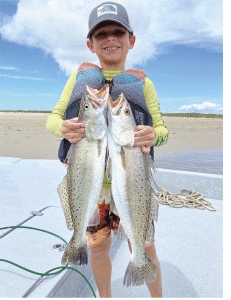 Cade Kuykendall age 7 fishing with his dad Glen Kuykendall and finding a solid stringer of trout while wading.