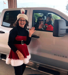 Susan Wallace greets folks at the Christmas Dinner drive-thru.