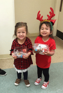 These little cuties are two of the group of Josie’s grandchildren who handed out homemade goodie boxes to appreciative seniors at the Senior Citizens’ Lunch a few days before Christmas.