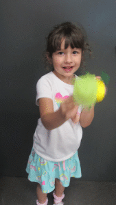 When learning about insects at POC Kindergarten, Josie Clark plays with her lighting bug craft. -Monica Peters