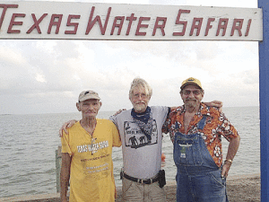 Lloyd “Bucky” Chatham, a native of Seadrift TX, has passed away. Bucky was one of the true characters of the Texas Water Safari. He was a 5 time finisher of the race, all in the top 15, with his best finish, 2nd place, in 1975 in a sculling rig. His final race was in 2003 with Tom Goynes, Joe Mynar, and John Dunn. They finished 6th overall, 5th Unlimited in 42 hrs, 35 minutes. Thank you,Paula Goynes, for this picture of Bucky (at left) with Tom Goynes and Owen West at the steps of the finish line, June 12, 2011.