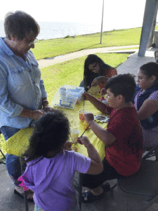 Diane assists children in a fun activity at the Community Worship Service. See article on page one.