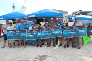 From left: Teams Findejo (First Place), Wild Bill (Second Place) and General Nice Guy (Third Place) with their checks after the conclusion of the 2021 Sharp Tooth Shootout at Froggies in Port O’Connor 