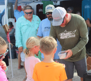 Tournament director Mark Robinson handed out shark teeth to the children who were in attendance. The teeth were donated by Team Slick Line.