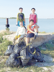 On September 18, 2021 The Seadrift Boy Scouts Troop/ Pack 106 Participated in the Beach/ Bay Cleanup. They Cleaned up The Westside Navigation Harbor  Seadrift in Calhoun County “The Hole”.Pictured L-R  top: Dominic Rendon, Nicolas Rendon. Bottom: Lathan Griggs, Cooper Rodriguez 