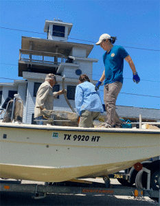 Loading up the large rudder found on the beach. 