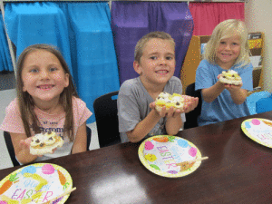 After learning about the Rainforest, POC Kindergarten enjoyed a “Rainforest Pizza”. Pictured left to right: Elizabeth Tolar, Brendan Brandt, and Kai Chance.   -Monica Peters